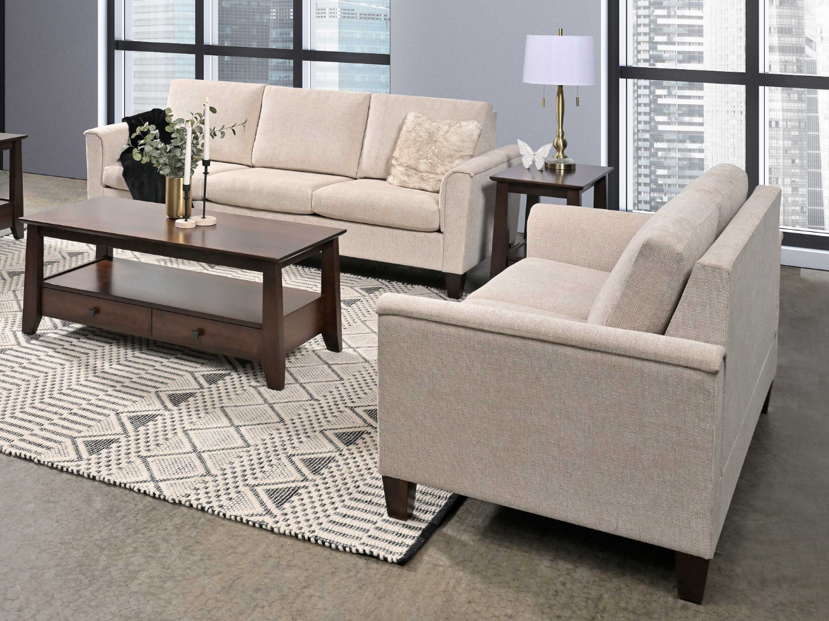 Biltmore Upholstered Sofa and Accent Chair in a light neutral fabric and richly stained coffee and end tables